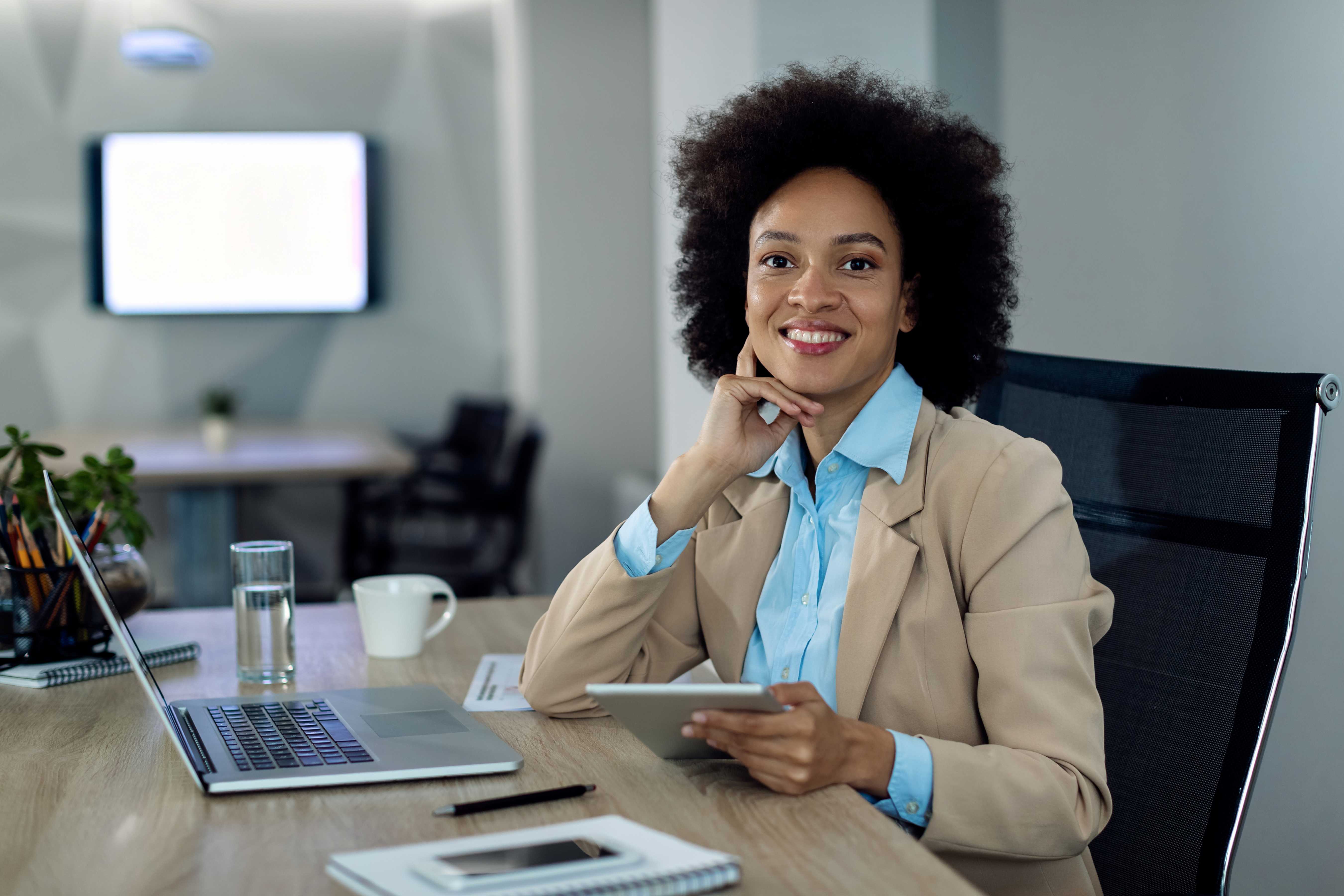 happy-african-american-businesswoman-working-touchpad-office-1 happy-african-american-businesswoman-working-touchpad-office-1
